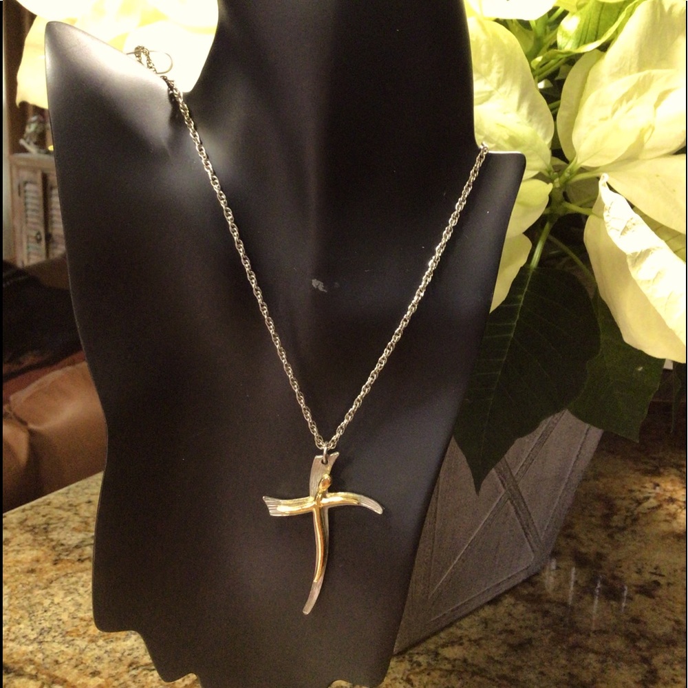 Vintage crucifix pendant on a silver colored chain.